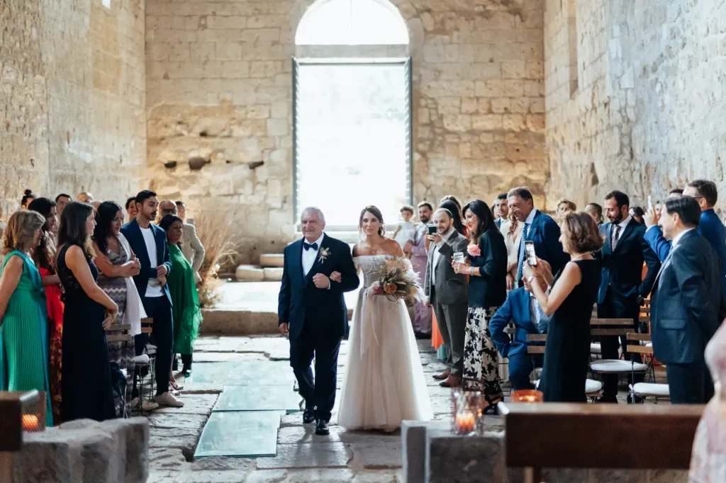 Entrance of the bride accompanied by her father in the church of san giusto abbey, tuscania
