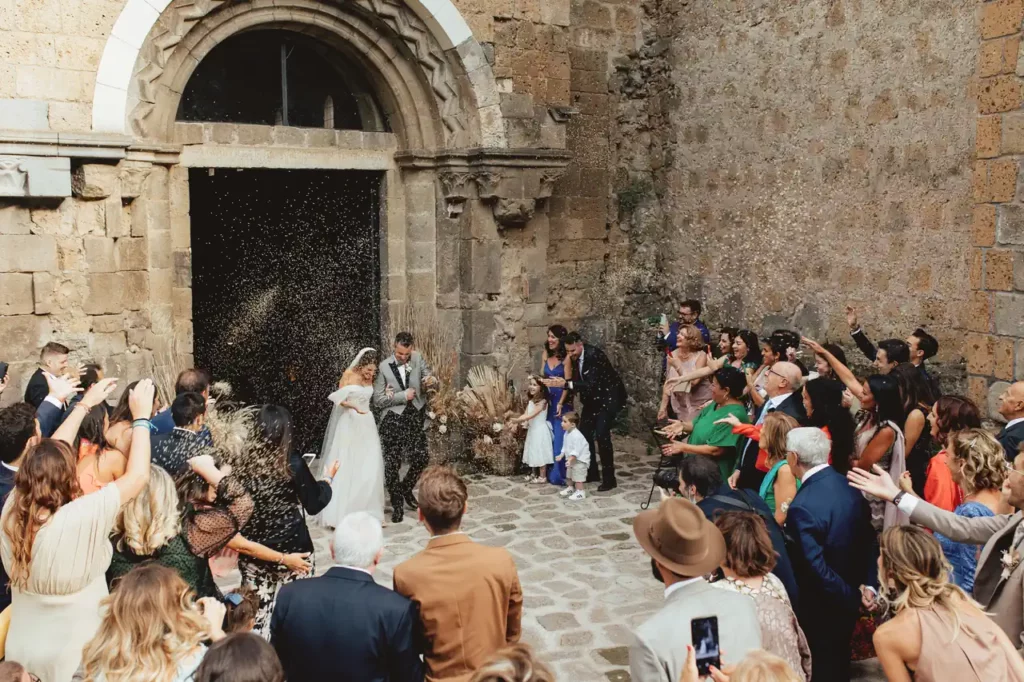 Rice throwing as the bride and groom exit the church of San Giusto Abbey, Tuscania