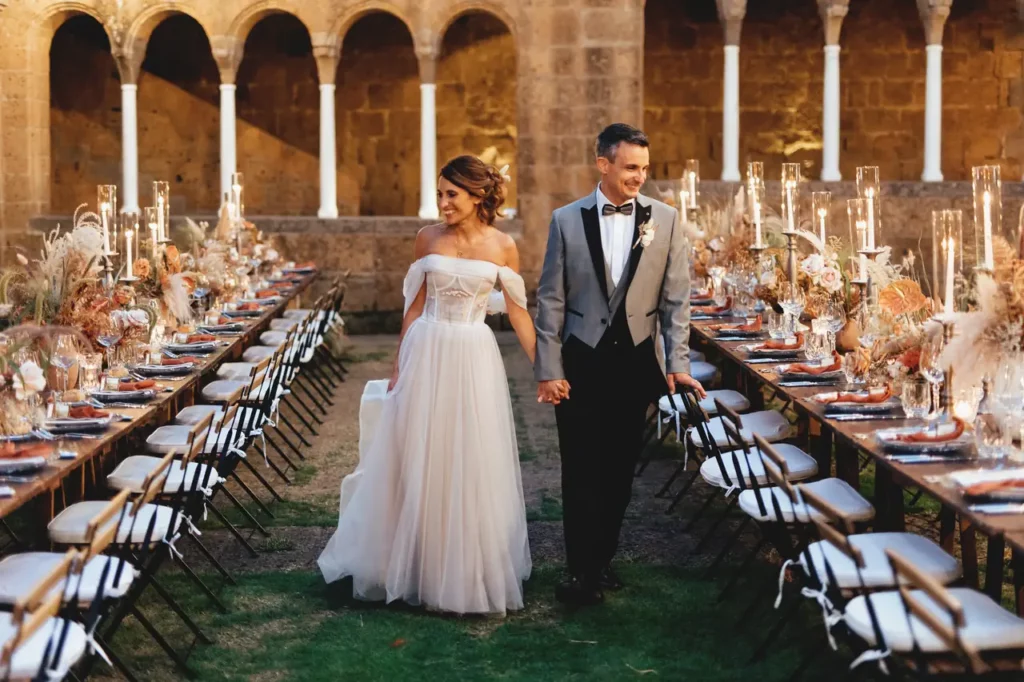 Happy newlyweds admire the setting of their reception at San Giusto Abbey, Tuscania