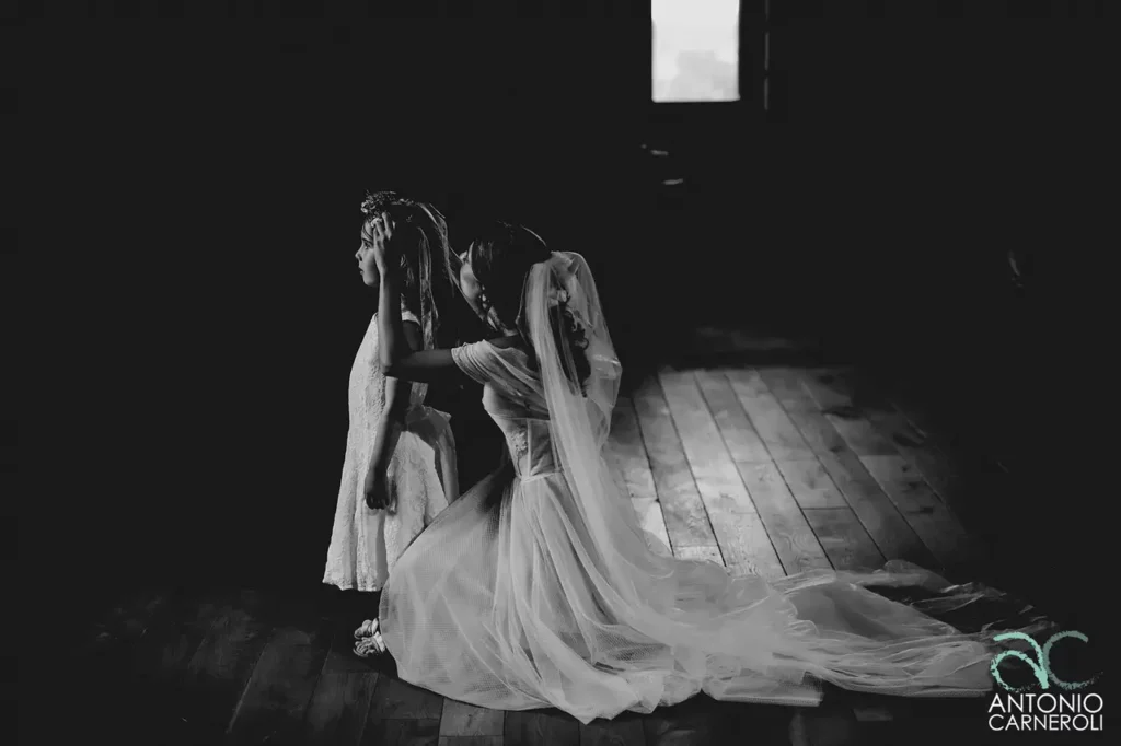 A black and white photo of a bride and her bridesmaid.