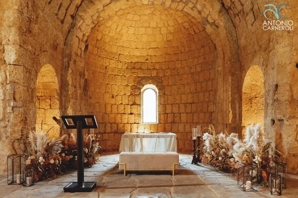 The wedding ceremony in the church of san giusto, an ancient stone building in tuscania.