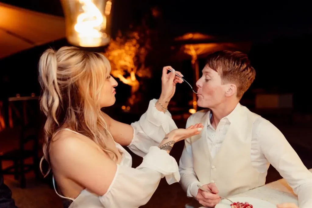 The bride feeds the groom a bite of cake during the reception.